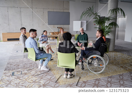 Corporate business team meeting with a manager or coach. Group of happy diverse, multiracial people sitting in a circle Corporate business team meeting with a manager or coach. Group of happy diverse, multiracial people sitting in a circle 123175323