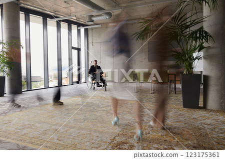 Business Team Led by Director in a Wheelchair Preparing for a Meeting in a Modern Office. Business Team Led by Director in a Wheelchair Preparing for a Meeting in a Modern Office. 123175361
