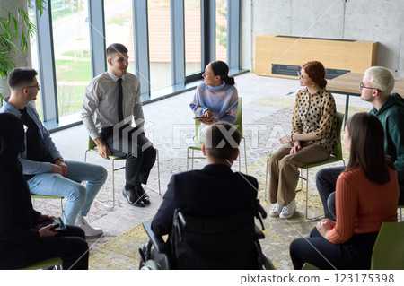 Corporate business team meeting with a manager or coach. Group of happy diverse, multiracial people sitting in a circle  123175398