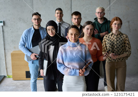 A diverse and determined team of business professionals stands confidently in an office, ready to tackle new business plans and challenges with a focus on success and growth A diverse and determined team of business professionals stands confidently in an office, ready to tackle new business plans and challenges with a focus on success and growth 123175421