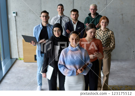 A diverse and determined team of business professionals stands confidently in an office, ready to tackle new business plans and challenges with a focus on success and growth A diverse and determined team of business professionals stands confidently in an office, ready to tackle new business plans and challenges with a focus on success and growth 123175512