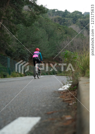 Cyclist on the roadway outside the city 123175633