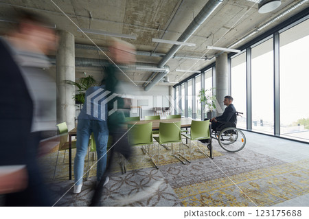 Business Team Led by Director in a Wheelchair Preparing for a Meeting in a Modern Office. Business Team Led by Director in a Wheelchair Preparing for a Meeting in a Modern Office. 123175688