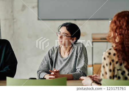 A diverse multiethnic business team engages in a collaborative meeting, discussing strategies and solutions in a modern office setting A diverse multiethnic business team engages in a collaborative meeting, discussing strategies and solutions in a modern office setting 123175761