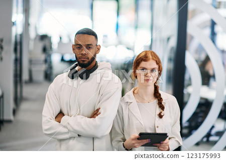 In a modern office African American businessman and his businesswoman colleague, with her striking orange hair, engage in collaborative problem-solving sessions In a modern office African American businessman and his businesswoman colleague, with her striking orange hair, engage in collaborative problem-solving sessions 123175993