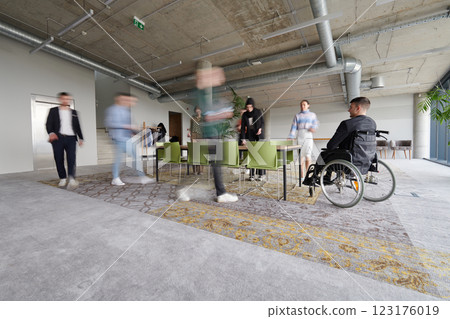 Business Team Led by Director in a Wheelchair Preparing for a Meeting in a Modern Office. Business Team Led by Director in a Wheelchair Preparing for a Meeting in a Modern Office. 123176019