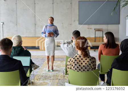 A businesswoman leader guiding a meeting with her colleagues, discussing business challenges, marketing strategies, and new plans for growth and success 123176032