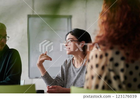 A diverse multiethnic business team engages in a collaborative meeting, discussing strategies and solutions in a modern office setting 123176039