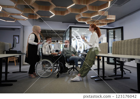 Young group of business people brainstorming together in a startup space, discussing business projects, investments, and solving challenges 123176042