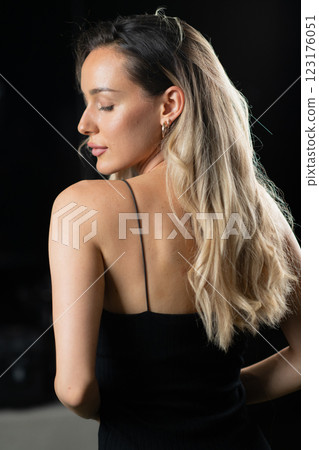 Radiant Elegance: A Stunning Blonde in a Black Dress Exuding Confidence and Beauty. Radiant Elegance: A Stunning Blonde in a Black Dress Exuding Confidence and Beauty. 123176051