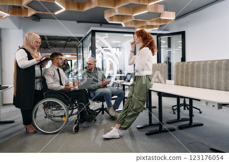 Young group of business people brainstorming together in a startup space, discussing business projects, investments, and solving challenges Young group of business people brainstorming together in a startup space, discussing business projects, investments, and solving challenges 123176054