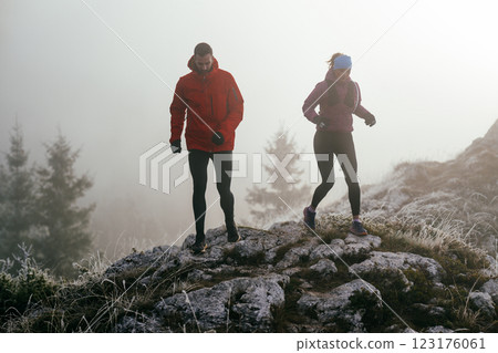 Trail running couple man and woman running on a mountain path 123176061