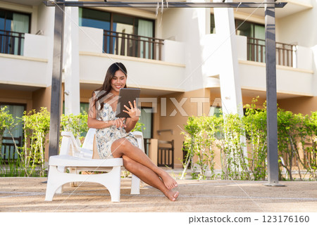 Young Asian woman using digital tablet computer outdoors Young Asian woman using digital tablet computer outdoors 123176160