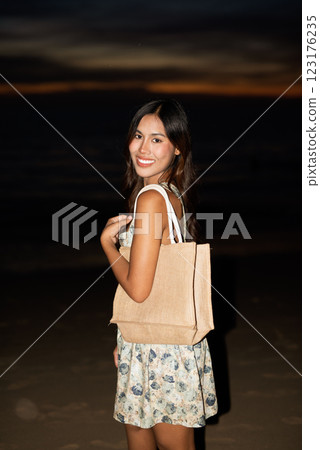 Portrait of young woman on the beach during night Portrait of young woman on the beach during night 123176235