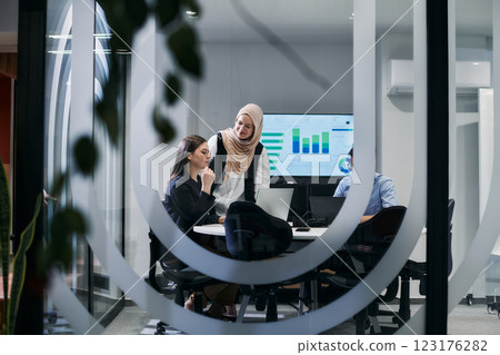 A diverse group of businessmen collaborates and tests a new virtual reality technology, wearing virtual glasses, showcasing innovation and creativity in their futuristic workspace 123176282