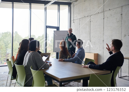 A diverse multiethnic business team engages in a collaborative meeting, discussing strategies and solutions in a modern office setting 123176352