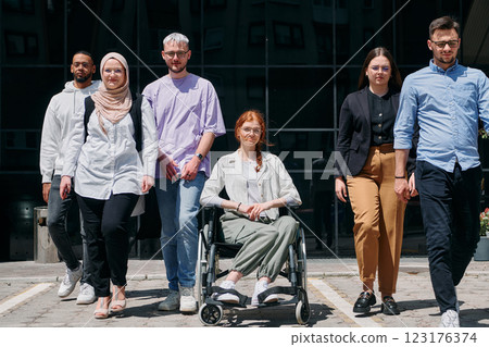 A diverse and confident group of businessmen posing together, with a businesswoman in a wheelchair radiating success, ambition, and unity, capturing the essence of a dynamic and inspiring business A diverse and confident group of businessmen posing together, with a businesswoman in a wheelchair radiating success, ambition, and unity, capturing the essence of a dynamic and inspiring business 123176374