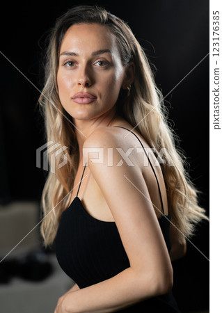 Radiant Elegance: A Stunning Blonde in a Black Dress Exuding Confidence and Beauty. 123176385