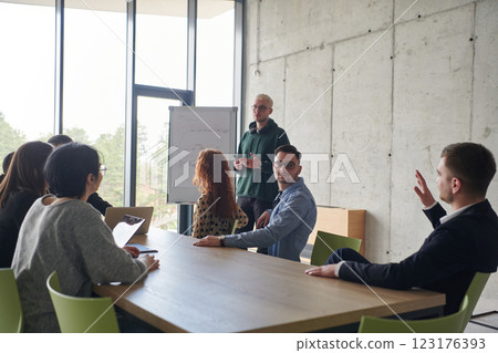 A diverse multiethnic business team engages in a collaborative meeting, discussing strategies and solutions in a modern office setting 123176393