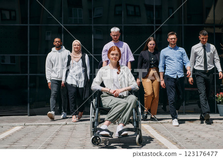 A diverse and confident group of businessmen posing together, with a businesswoman in a wheelchair radiating success, ambition, and unity, capturing the essence of a dynamic and inspiring business A diverse and confident group of businessmen posing together, with a businesswoman in a wheelchair radiating success, ambition, and unity, capturing the essence of a dynamic and inspiring business 123176477