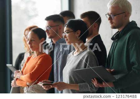 A group of accomplished business professionals stands together in an office, exuding unity, confidence, and a shared commitment to success and innovation. A group of accomplished business professionals stands together in an office, exuding unity, confidence, and a shared commitment to success and innovation. 123176488
