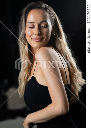 Radiant Elegance: A Stunning Blonde in a Black Dress Exuding Confidence and Beauty. Radiant Elegance: A Stunning Blonde in a Black Dress Exuding Confidence and Beauty. 123176521