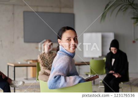 A diverse multiethnic business team engages in a collaborative meeting, discussing strategies and solutions in a modern office setting 123176536