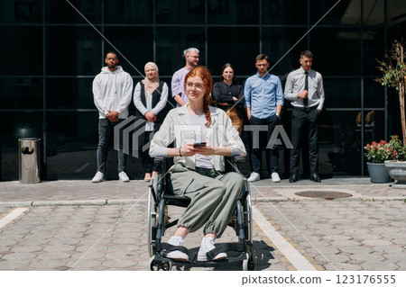 A diverse and confident group of businessmen posing together, with a businesswoman in a wheelchair radiating success, ambition, and unity, capturing the essence of a dynamic and inspiring business A diverse and confident group of businessmen posing together, with a businesswoman in a wheelchair radiating success, ambition, and unity, capturing the essence of a dynamic and inspiring business 123176555