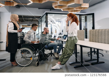 Young group of business people brainstorming together in a startup space, discussing business projects, investments, and solving challenges Young group of business people brainstorming together in a startup space, discussing business projects, investments, and solving challenges 123176566