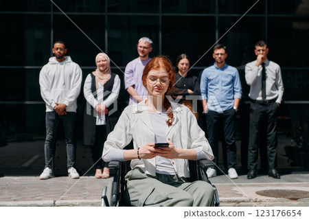 A diverse and confident group of businessmen posing together, with a businesswoman in a wheelchair radiating success, ambition, and unity, capturing the essence of a dynamic and inspiring business A diverse and confident group of businessmen posing together, with a businesswoman in a wheelchair radiating success, ambition, and unity, capturing the essence of a dynamic and inspiring business 123176654