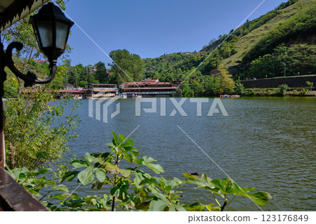 Sera Golu lake (Trabzon lake) in Trabzon, Turkey daylight view with people in boats and restaurants in background. 123176849