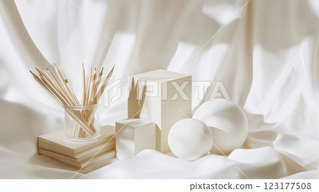 Still life for a drawing lesson using minimalist geometric plaster forms and draperies, monochrome light colors, copy space. 123177508