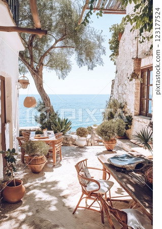 View of the terrace of a cozy hotel in boho style, overlooking the sea, summer vacation concept. 123177524