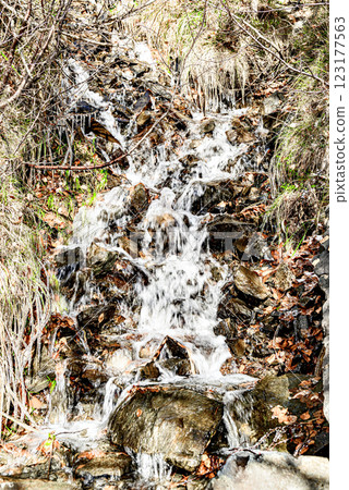Waterfall, small water source on the slope of Lake Saint Maurice, in the Aigues Tortes National Park, Lleida 123177563