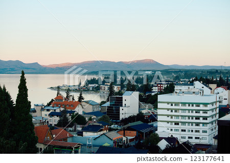 Buildings on the shore, against the backdrop of the lake and mountains 123177641