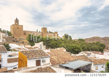 Ancient castle in Antequera town in Spain, overlooking a town with terracotta rooftops. A picturesque scene of history and architecture. Ancient castle in Antequera town in Spain, overlooking a town with terracotta rooftops. A picturesque scene of history and architecture. 123178205