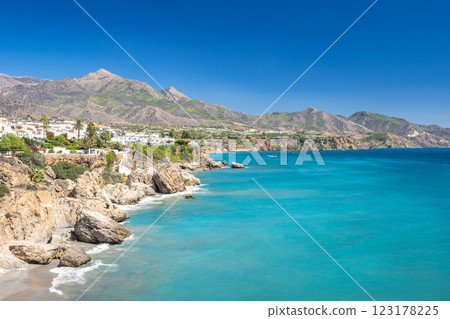 Nerja town, a resort of The Costa del Sol seaside region in Andalusia in the south of Spain, view from the Balcon de Europa square. Stunning coastal view with turquoise water. 123178225