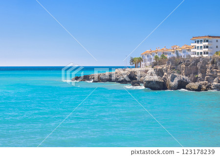 Nerja town, a resort of The Costa del Sol seaside region in Andalusia in the south of Spain. Coastal villas overlooking a turquoise sea on a sunny day. Relaxing beach view. 123178239