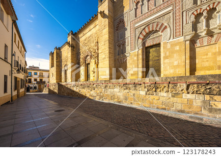 The Mosque Cathedral of Cordoba, Cathedral of Our Lady of the Assumption in Cordoba town in Spain. Ancient stone architecture and narrow street scene bathed in sunlight. 123178243