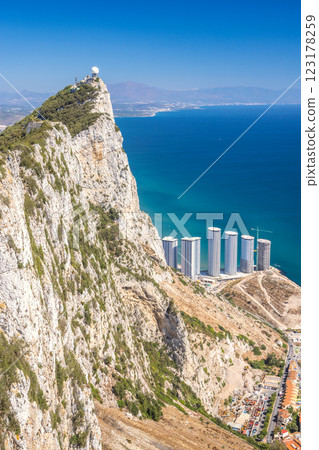 Gibraltar, British Overseas Territory and city on the Iberian Peninsula. Coastal clifftop view with modern buildings and ocean Gibraltar, British Overseas Territory and city on the Iberian Peninsula. Coastal clifftop view with modern buildings and ocean 123178259