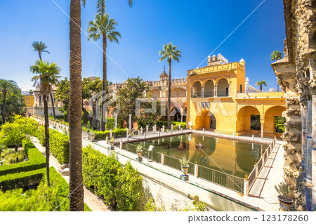 The Alcazar of Seville, historic royal palace in Seville town, Andalusia, Spain. Serene palace gardens with reflecting pool and lush greenery. 123178260