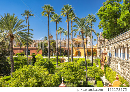 The Alcazar of Seville, historic royal palace in Seville town, Andalusia, Spain. Sun-drenched palace gardens with palm trees and lush greenery. A tranquil oasis. The Alcazar of Seville, historic royal palace in Seville town, Andalusia, Spain. Sun-drenched palace gardens with palm trees and lush greenery. A tranquil oasis. 123178275