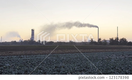 Heavy gray smoke is poured from the chimney pipes of thermal power plant. Carbon dioxide emitting from chimneys from industrial factory into the atmosphere. Concept of environmental pollution problem Heavy gray smoke is poured from the chimney pipes of thermal power plant. Carbon dioxide emitting from chimneys from industrial factory into the atmosphere. Concept of environmental pollution problem 123178398