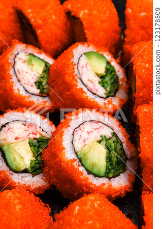 Delicious Fresh Sushi Rolls Presenting Exquisitely on a Black Background 123178809