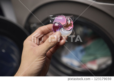 Using Laundry Detergent Pods While Doing Laundry in the Washing Machine with Clothes Using Laundry Detergent Pods While Doing Laundry in the Washing Machine with Clothes 123179030