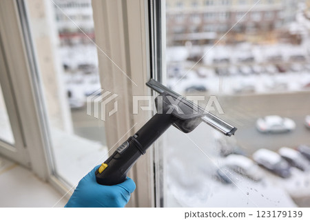 Winter Window Cleaning performed with a Squeegee for optimal results and clarity Winter Window Cleaning performed with a Squeegee for optimal results and clarity 123179139