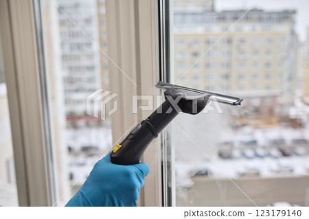 Winter Window Cleaning performed with a Squeegee for optimal results and clarity Winter Window Cleaning performed with a Squeegee for optimal results and clarity 123179140