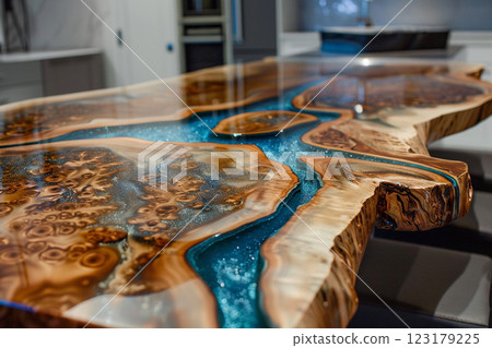 Epoxy resin wood table with blue design, showcasing intricate details and natural wood textures in a modern interior . 123179225