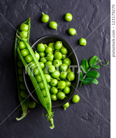 Fresh green pea beans in a bowl placed on a black background 123179270