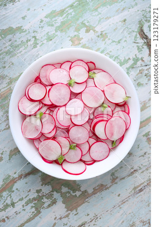 Fresh radish salad with thin slices on a white plate Fresh radish salad with thin slices on a white plate 123179271